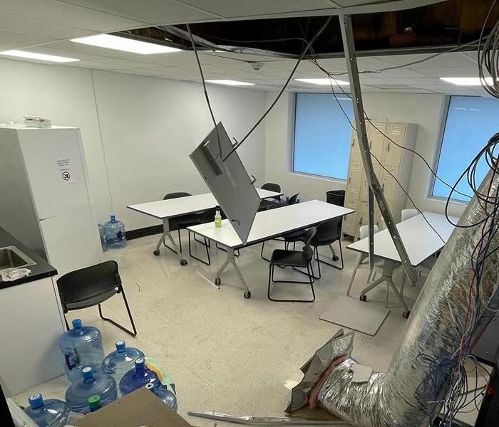 storm affected businesses breakroom, scattered about ceiling tiles and HVAC tubing